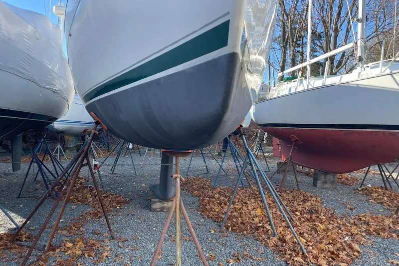 Slide: The Image of Beneteau Oceanis 361 sailboat from 2000 on stands, surrounded by autumn leaves. - 32