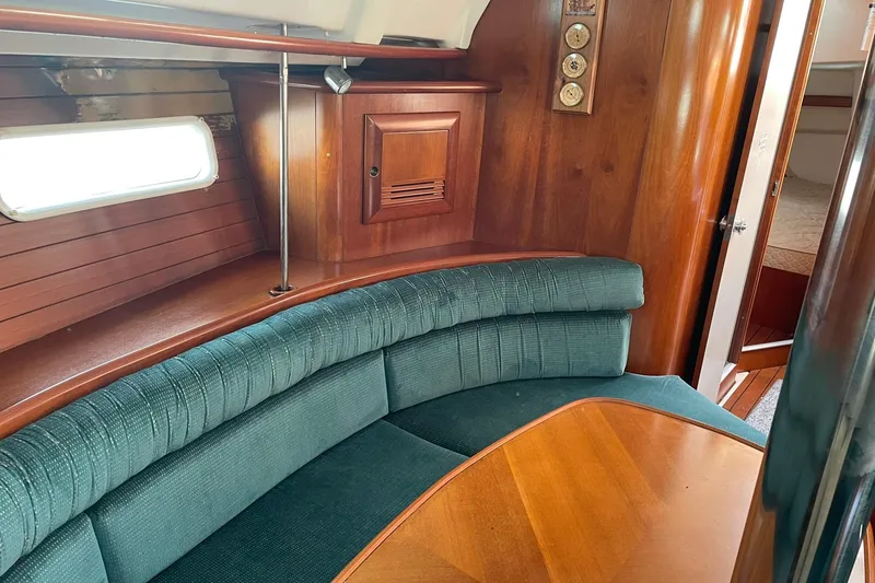 Slide: The Image of Interior of 2000 Beneteau Oceanis 361 sailboat with wood finish and green seating. - 33