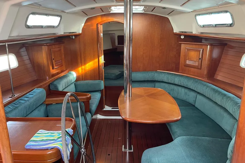 Slide: The Image of Interior of 2000 Beneteau Oceanis 361 sailboat with wood finish and teal seating. - 34