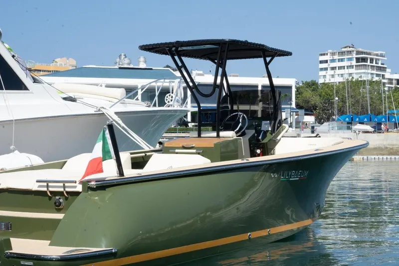 Slide: The Image of 2026 Lilybaeum Levanzo 25 Lounge Deck boat docked in marina, Italian flag displayed. - 2