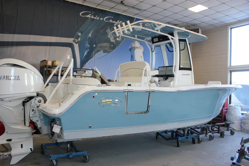 The Image of 2025 Sea Hunt Ultra 239 SE boat in showroom, featuring Yamaha outboard motor. - 0