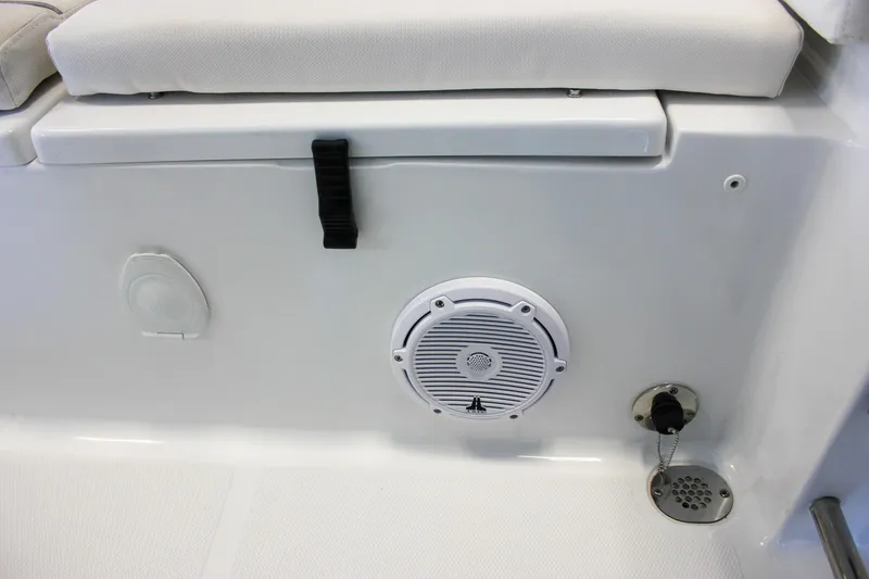 Slide: The Image of 2025 Sea Hunt Ultra 239 SE boat interior with speaker and seating detail. - 13