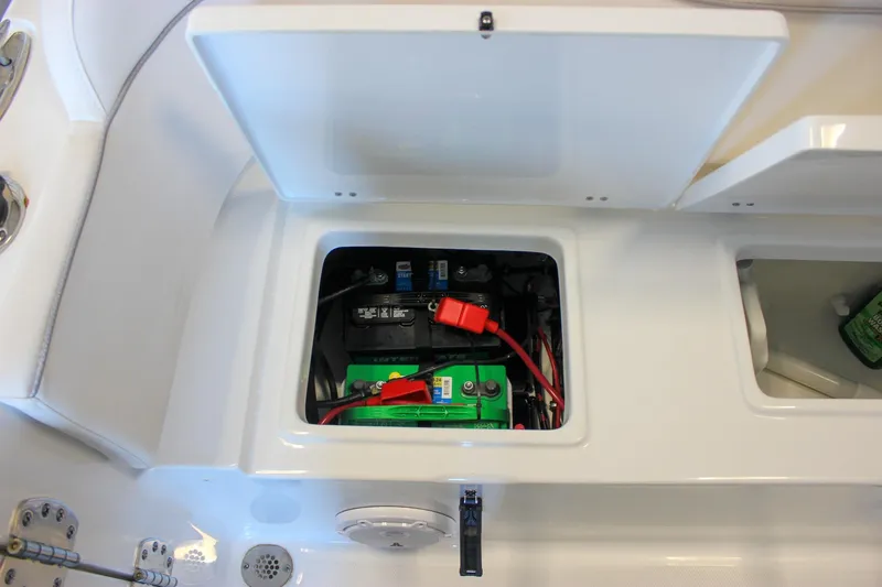 Slide: The Image of Battery compartment of 2025 Sea Hunt Ultra 239 SE boat, featuring organized wiring. - 16