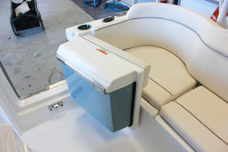Slide: The Image of 2025 Sea Hunt Ultra 239 SE boat interior with cushioned seating and built-in cooler. - 18