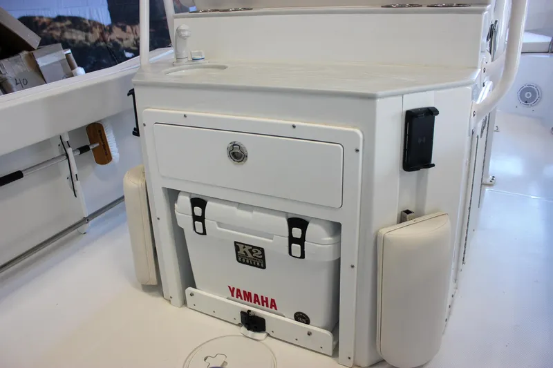 Slide: The Image of 2025 Sea Hunt Ultra 239 SE boat interior with Yamaha cooler and storage compartment. - 19