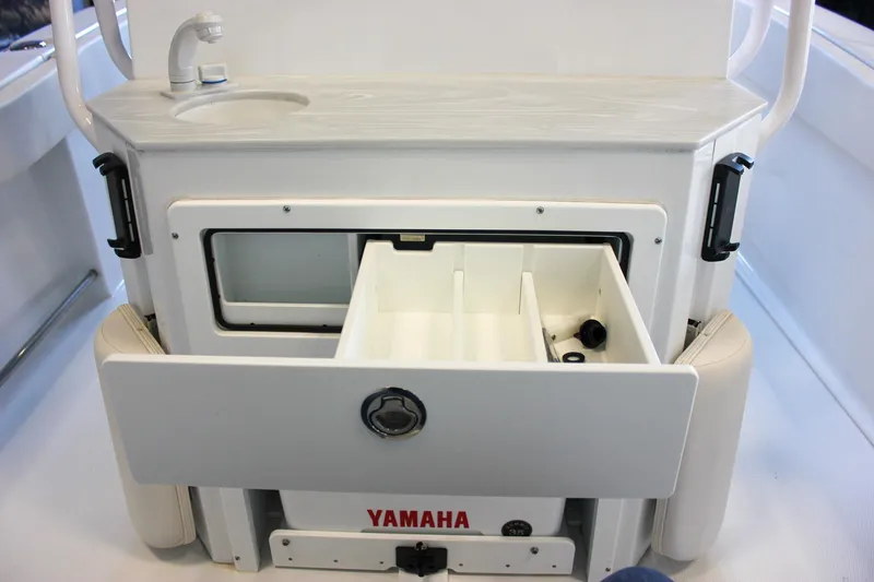 Slide: The Image of 2025 Sea Hunt Ultra 239 SE boat console with storage compartments and sink. - 21