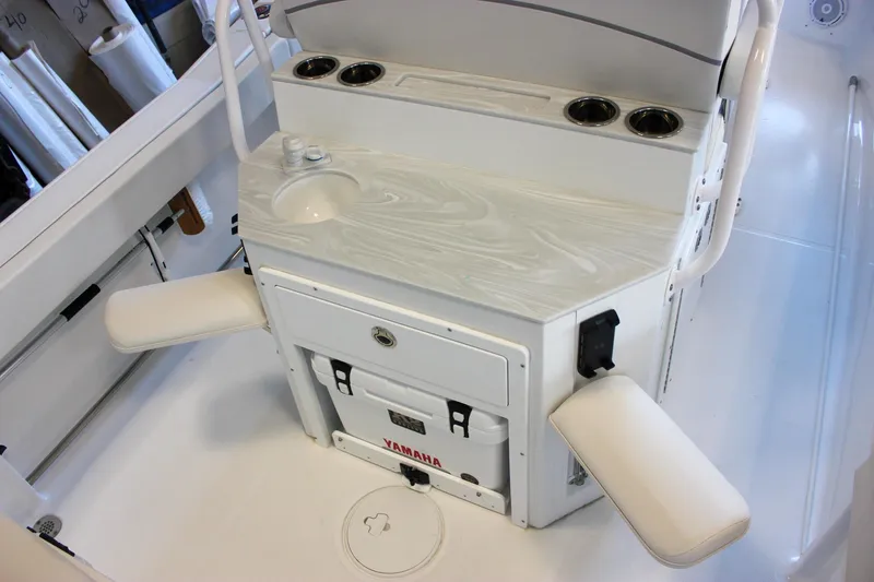 Slide: The Image of 2025 Sea Hunt Ultra 239 SE boat interior with sink, cup holders, and seating. - 23