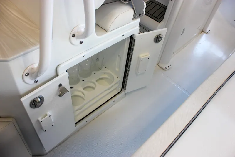 Slide: The Image of 2025 Sea Hunt Ultra 239 SE boat interior with open storage compartment. - 27