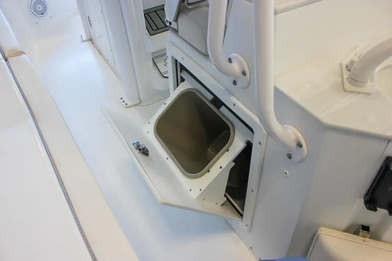 Slide: The Image of 2025 Sea Hunt Ultra 239 SE boat interior with open storage compartment. - 29