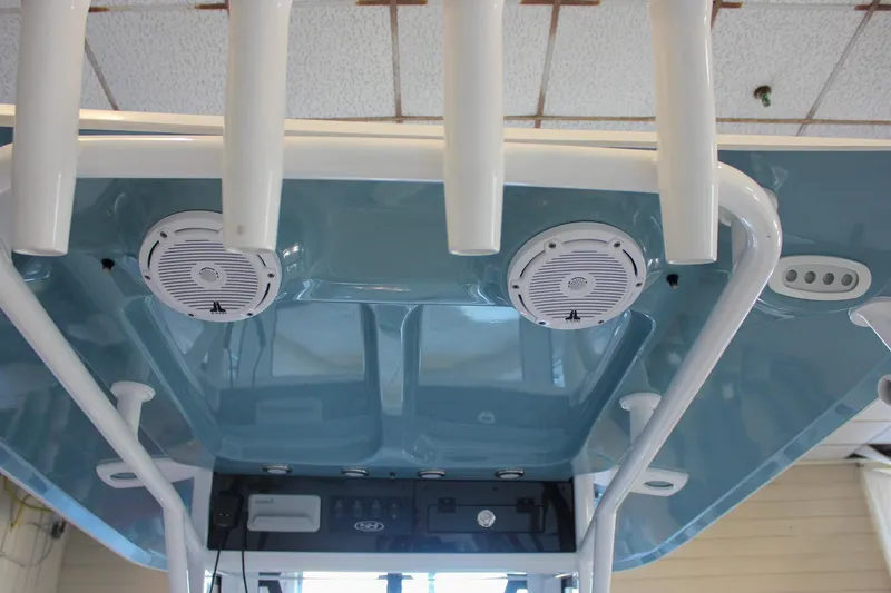 Slide: The Image of 2025 Sea Hunt Ultra 239 SE boat interior with speakers and rod holders. - 30