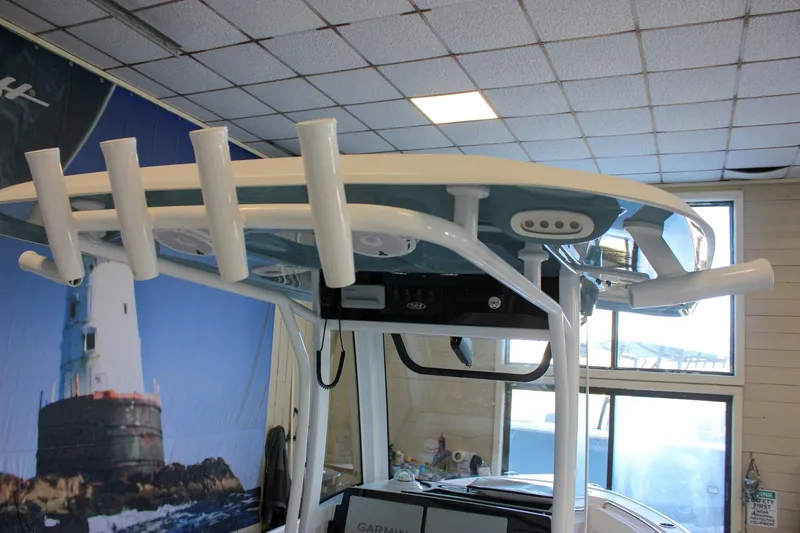 Slide: The Image of 2025 Sea Hunt Ultra 239 SE boat with rod holders and electronics, indoors. - 31