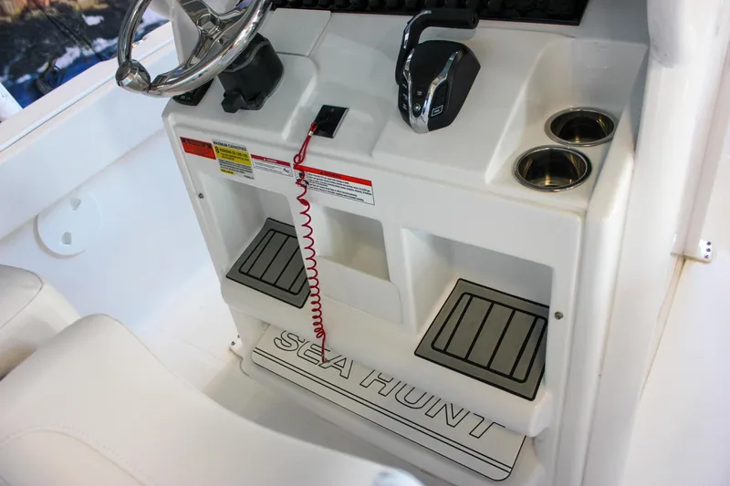 Slide: The Image of 2025 Sea Hunt Ultra 239 SE boat console with steering wheel and controls. - 34