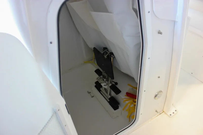 Slide: The Image of 2025 Sea Hunt Ultra 239 SE storage compartment with equipment and accessories. - 43