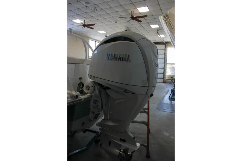 Slide: The Image of 2025 Sea Hunt Ultra 239 SE with Yamaha outboard motor in a garage setting. - 7
