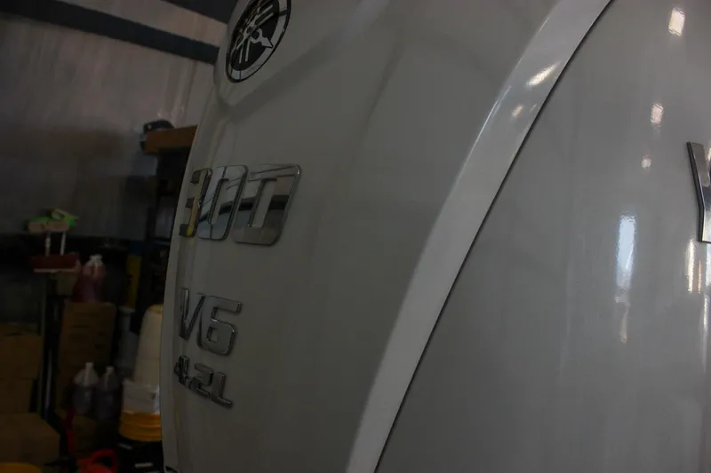 Slide: The Image of 2025 Sea Hunt Ultra 239 SE with Yamaha 300 V6 engine in a workshop setting. - 8