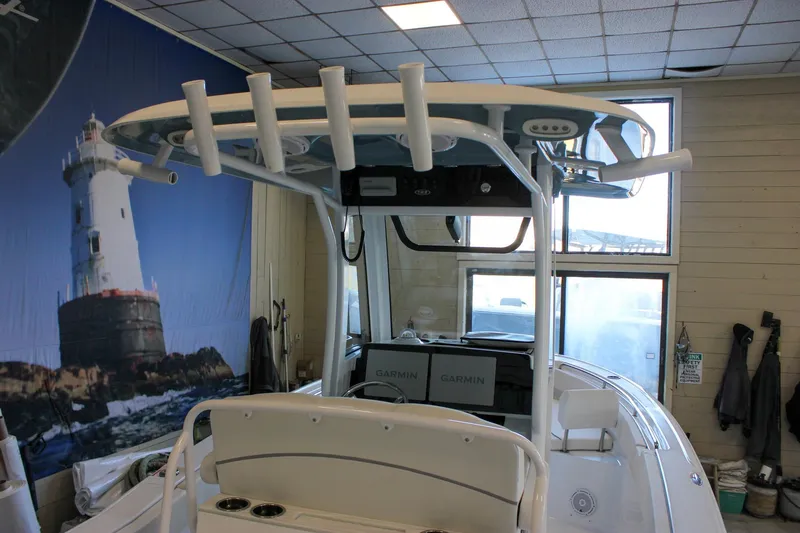 Slide: The Image of 2025 Sea Hunt Ultra 239 SE boat interior with fishing rod holders and Garmin electronics. - 9