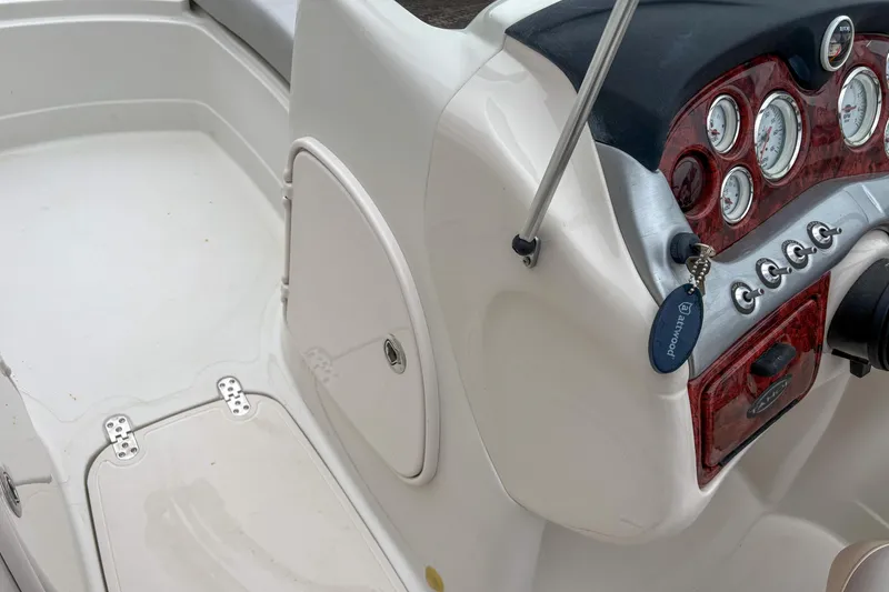 Slide: The Image of 2012 Tahoe 216 WT boat dashboard with gauges and controls. - 11