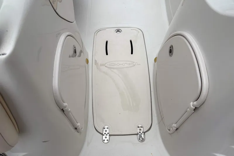 Slide: The Image of Interior view of a 2012 Tahoe 216 WT boat, featuring storage compartments and a central hatch. - 12