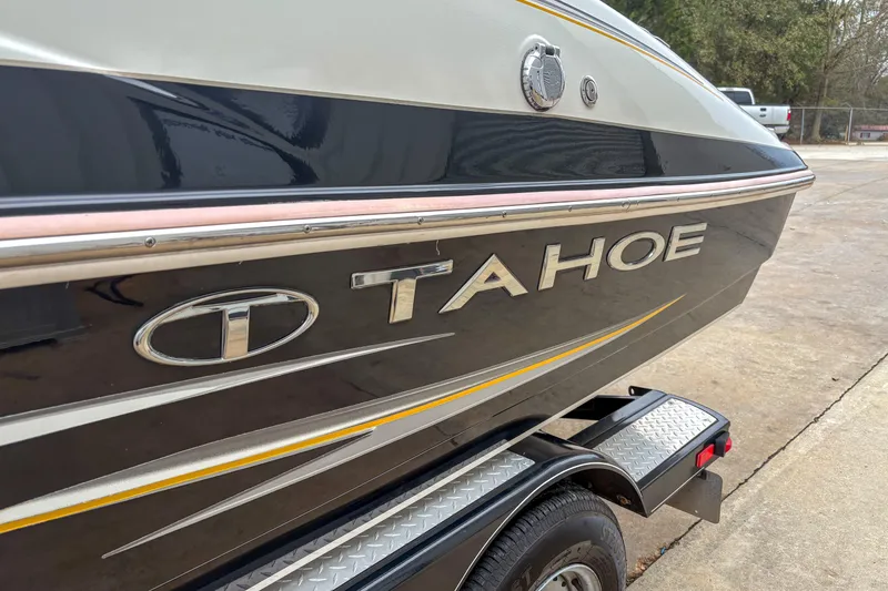 Slide: The Image of 2012 Tahoe 216 WT boat on trailer, side view with logo visible. - 2