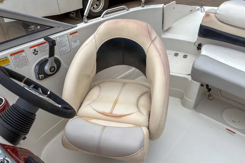 Slide: The Image of 2012 Tahoe 216 WT boat interior with steering wheel and cushioned seat. - 5