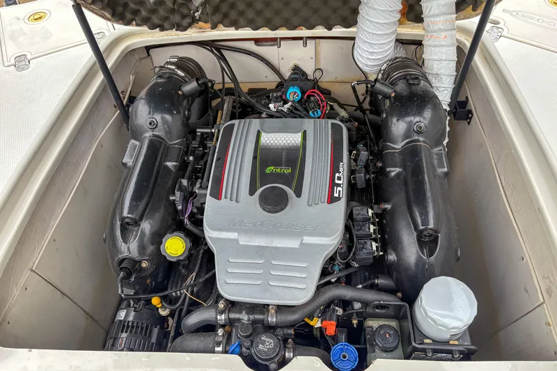 Slide: The Image of Engine compartment of a 2012 Tahoe 216 WT boat, featuring a MerCruiser 5.0 MPI engine. - 6