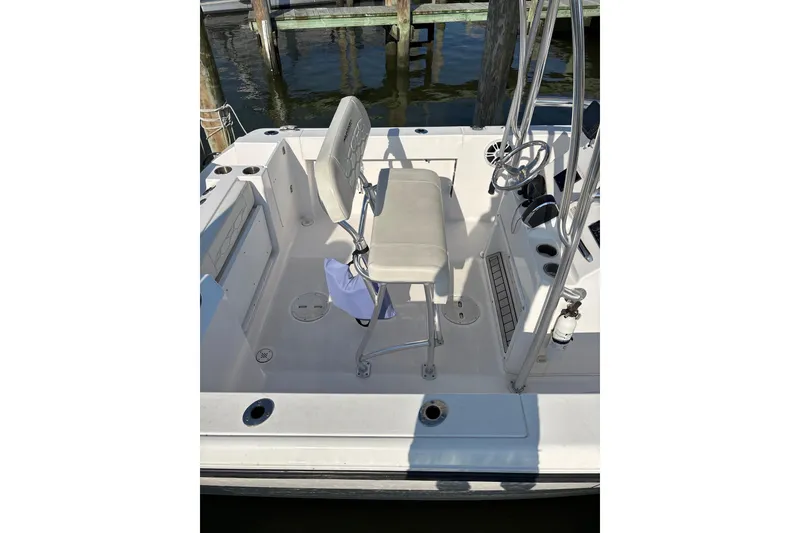 Slide: The Image of 2023 Aquasport 22CC boat interior with helm seat and steering wheel. - 6