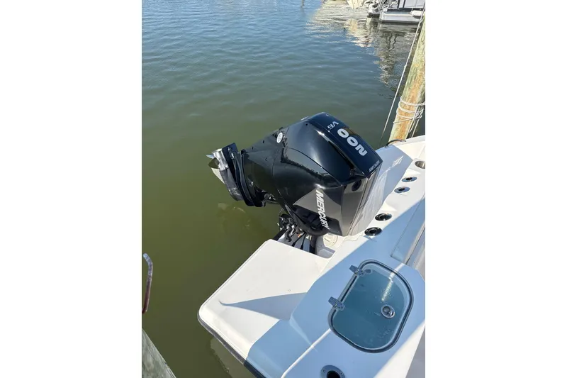 Slide: The Image of 2023 Aquasport 22CC boat with Mercury 200 HP outboard motor on water. - 9