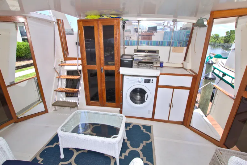 Slide: The Image of Interior of 1987 Jefferson 42 Sundeck yacht with washer, cabinets, and wicker furniture. - 13