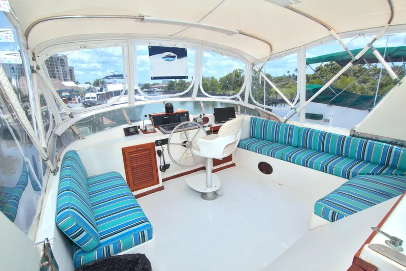 Slide: The Image of 1987 Jefferson 42 Sundeck yacht interior with striped seating and steering wheel. - 14