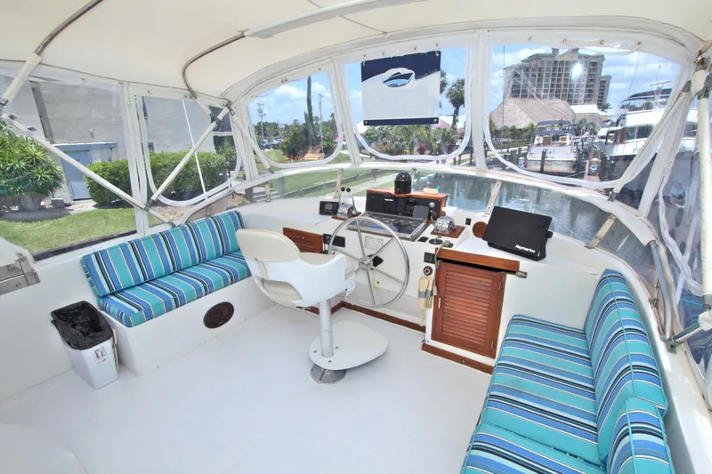 Slide: The Image of 1987 Jefferson 42 Sundeck boat interior with striped seating and helm station. - 15