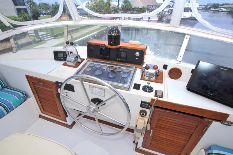 Slide: The Image of 1987 Jefferson 42 Sundeck helm with steering wheel, controls, and navigation equipment. - 17