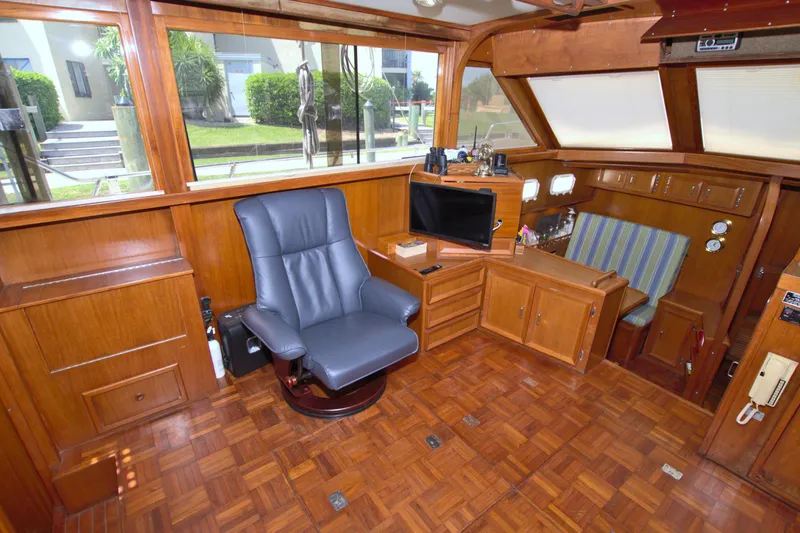 Slide: The Image of Interior of 1987 Jefferson 42 Sundeck yacht with wood paneling and seating. - 25