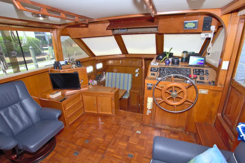 Slide: The Image of 1987 Jefferson 42 Sundeck interior with wooden helm, seating, and navigation equipment. - 27