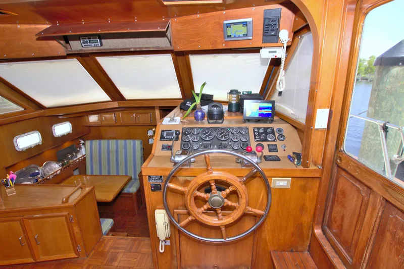 Slide: The Image of 1987 Jefferson 42 Sundeck yacht interior with wooden helm, steering wheel, and navigation equipment. - 29