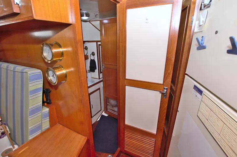 Slide: The Image of 1987 Jefferson 42 Sundeck interior with wood paneling and nautical decor. - 35