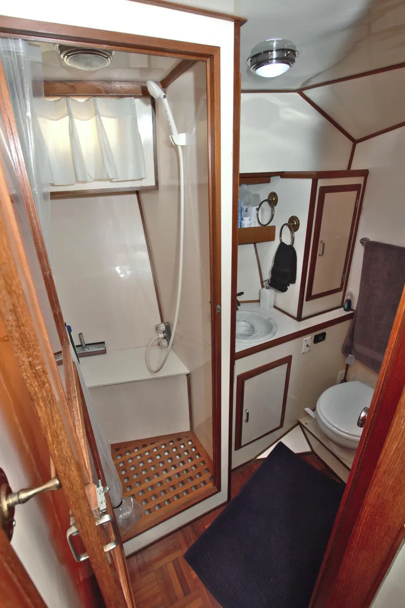 Slide: The Image of 1987 Jefferson 42 Sundeck yacht bathroom with shower, sink, and toilet. - 36