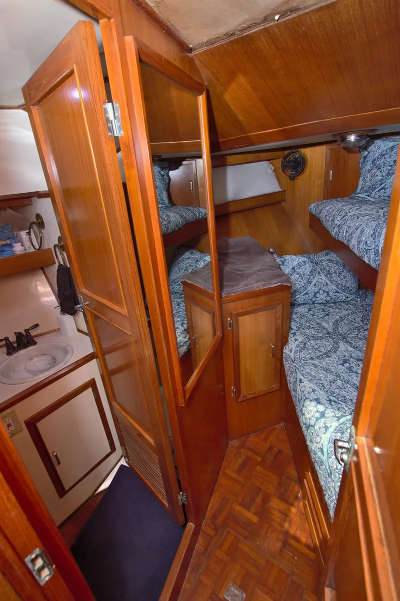 Slide: The Image of 1987 Jefferson 42 Sundeck interior with wooden cabinetry and cozy bunk beds. - 38