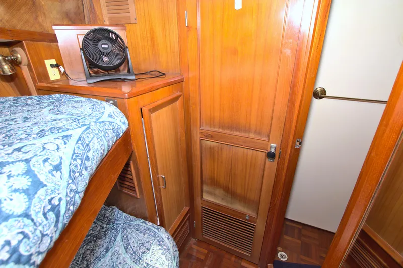 Slide: The Image of Interior of 1987 Jefferson 42 Sundeck with wooden cabinetry and patterned bedding. - 40
