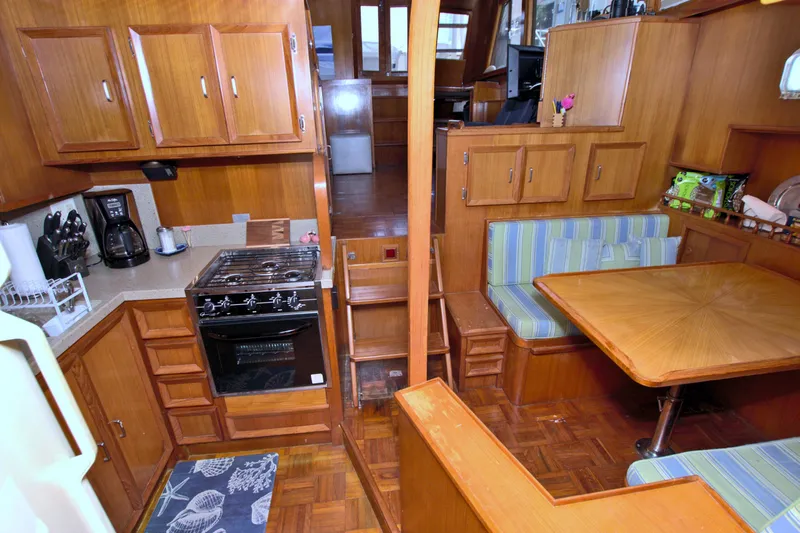 Slide: The Image of 1987 Jefferson 42 Sundeck interior with wood cabinetry, dining area, and kitchen appliances. - 41