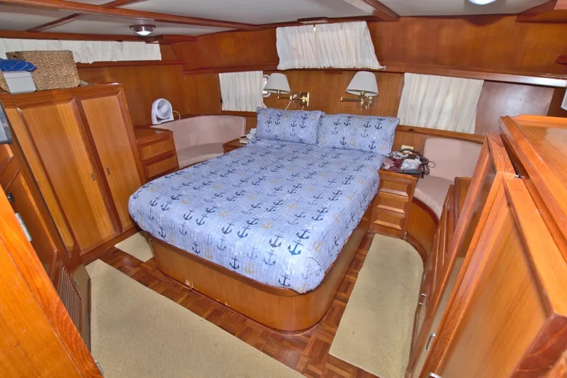 Slide: The Image of 1987 Jefferson 42 Sundeck bedroom with nautical-themed bedding and wooden interior. - 44