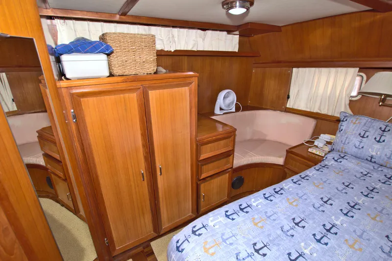 Slide: The Image of 1987 Jefferson 42 Sundeck cabin with wooden interior, bed, and storage. - 46