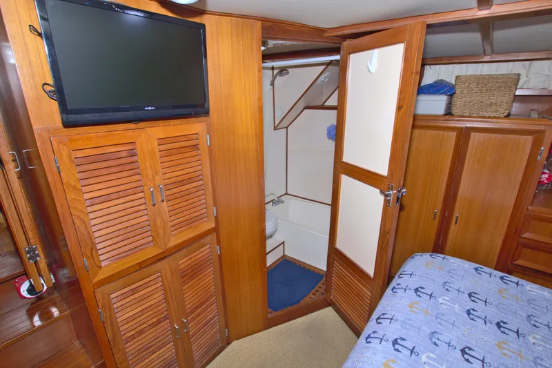 Slide: The Image of Interior of 1987 Jefferson 42 Sundeck yacht with wood paneling and modern amenities. - 47