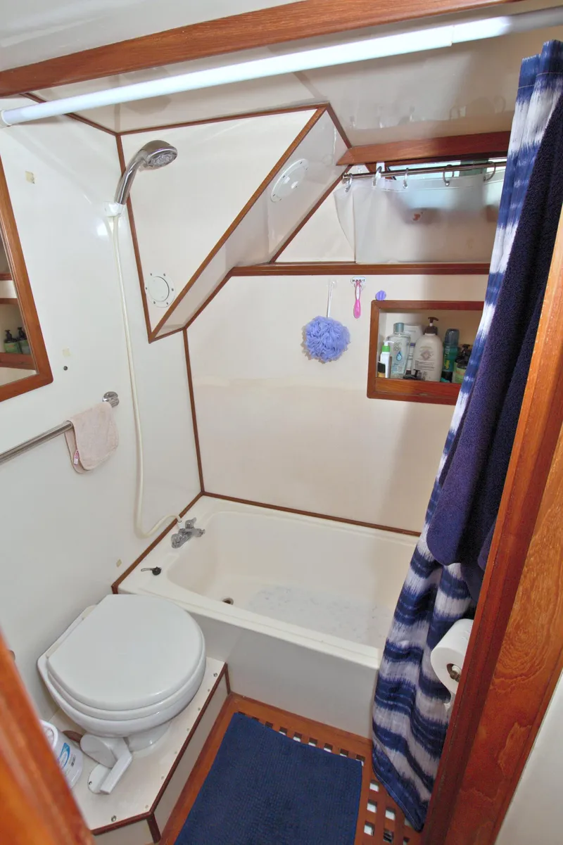 Slide: The Image of 1987 Jefferson 42 Sundeck bathroom with shower, toilet, and wooden accents. - 49