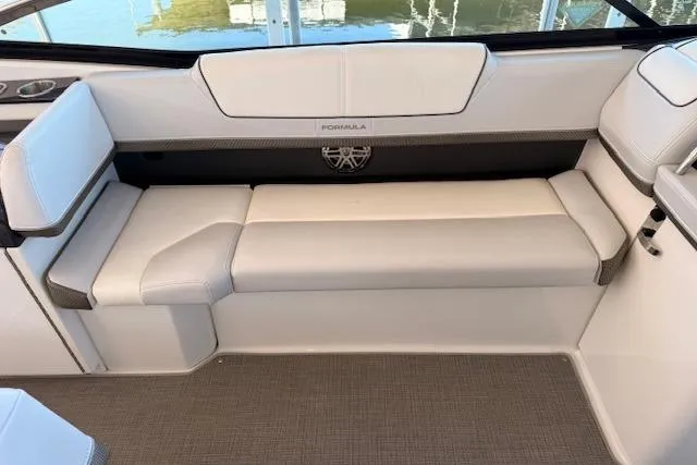 Slide: The Image of 2019 Formula 310 Bowrider I/O interior seating with white upholstery and sleek design. - 10