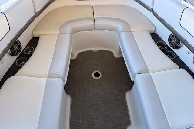 Slide: The Image of 2019 Formula 310 Bowrider I/O interior with white cushioned seating and cup holders. - 8