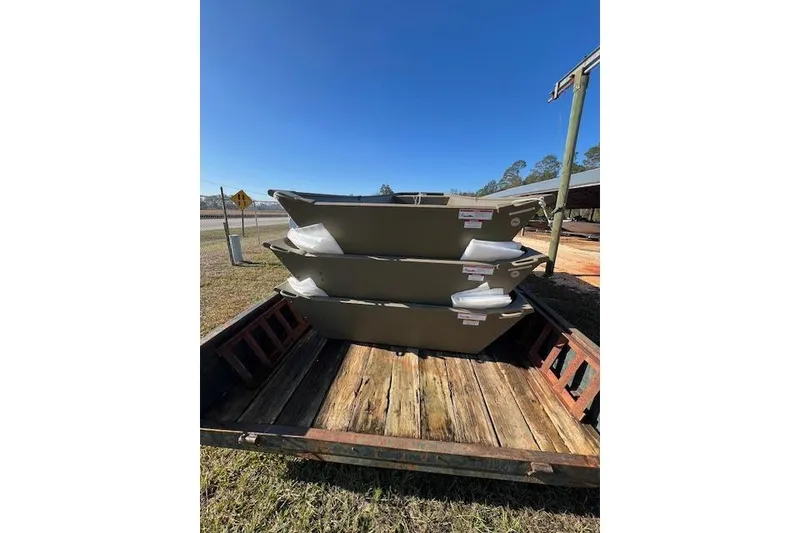 Slide: The Image of Stacked G3 1442 boats on trailer, 2025 model, outdoors under clear blue sky. - 2
