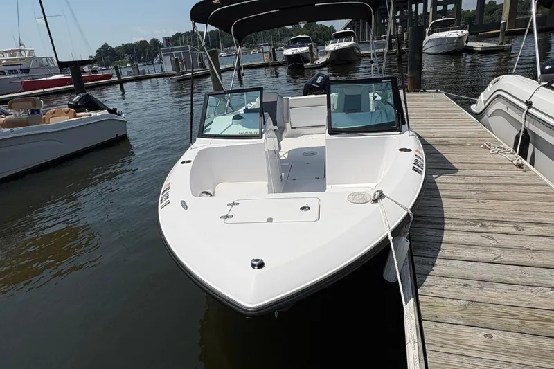 Slide: The Image of 2023 Aquasport 22CC boat docked at marina, featuring sleek design and spacious deck. - 3