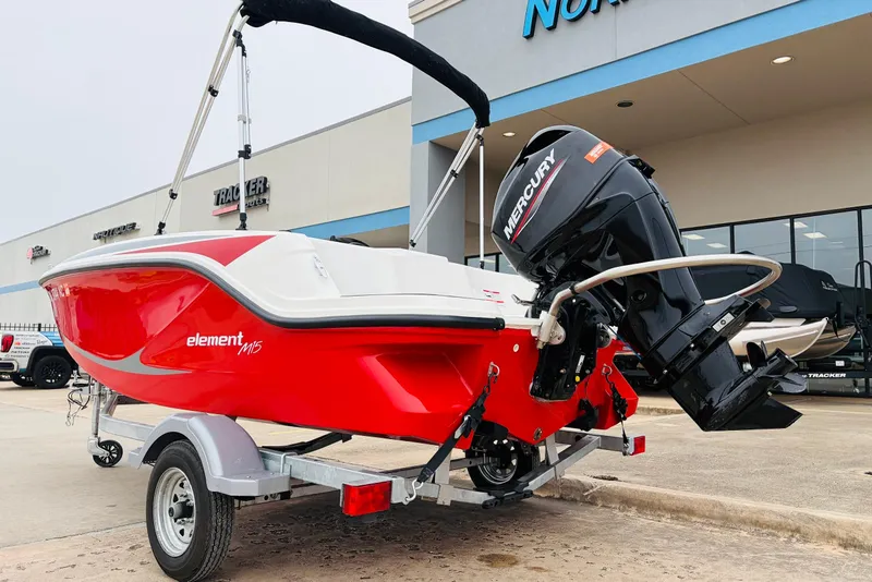 Slide: The Image of 2023 Bayliner Element M15 boat with Mercury engine on trailer, displayed outdoors. - 10
