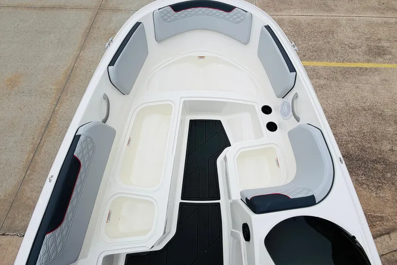 Slide: The Image of 2023 Bayliner Element M15 boat interior with gray seating and storage compartments. - 18