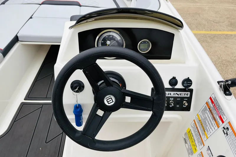 Slide: The Image of 2023 Bayliner Element M15 dashboard with steering wheel and control panel. - 23